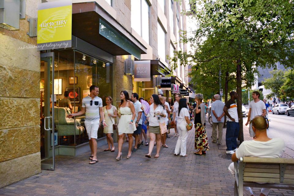 This Aug. 3, 2013 photo provided by the 2ND Street District shows pedestrians in Austin’s 2ND Street District during an event called White Linen Night. The area in Austin’s downtown hosts a variety of free events and is home to sidewalk cafes, shops and a statue of Willie Nelson. It’s one of a number of free places to visit and explore around Austin. (AP Photo/2ND Street District, Sabrina Bean Photography)