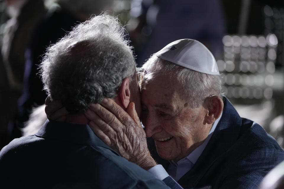 Holocaust survivor David Schaecter, 94, right, embraces a friend during an event commemorating Kristallnacht, the 1938 government-backed pogroms against Jews in Germany and Austria, at the Holocaust Memorial in Miami Beach, Fla., Sunday, Nov. 5, 2023. Schaecter helped found Miami Beach’s Holocaust Memorial where he volunteers educate youth about the Nazis' systematic killing of 6 million Jews. (AP Photo/Rebecca Blackwell)