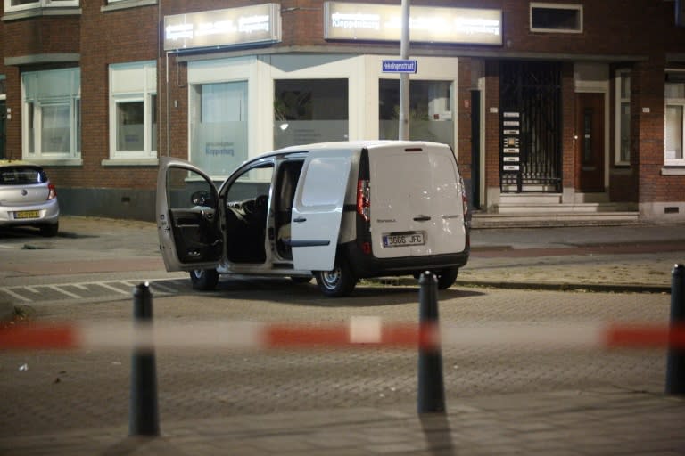 Police inspect a van with a Spanish numberplate and carrying gas canisters near the evacuated Maassilo concert hall in Rotterdam, The Netherlands