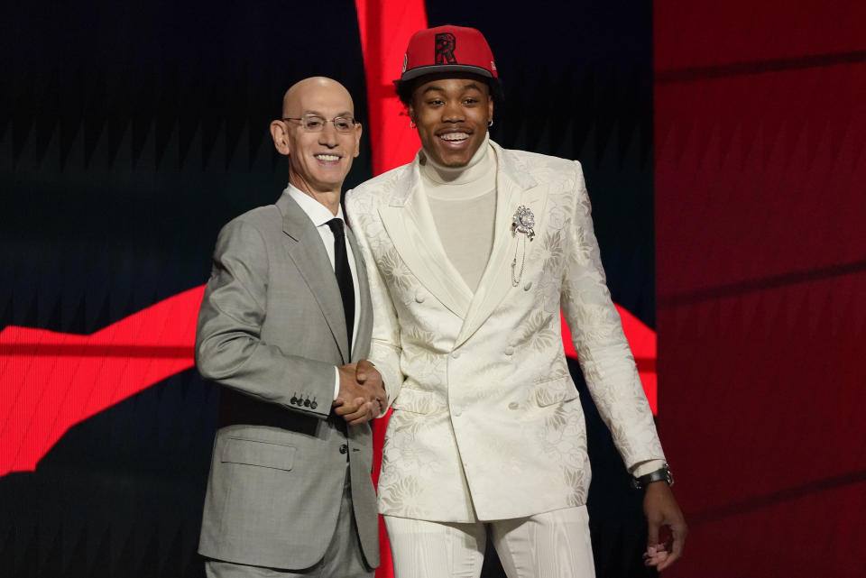 Scottie Barnes, right, poses for a photo with NBA Commissioner Adam Silver after being selected fourth overall by the Toronto Raptors during the first round of the NBA basketball draft, Thursday, July 29, 2021, in New York. (AP Photo/Corey Sipkin)