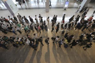 Passengers wearing face masks to help protect against the spread of the coronavirus line up to board planes ahead of the upcoming Chuseok holiday, the Korean version of Thanksgiving Day, at the domestic flight terminal of Gimpo airport in Seoul, South Korea, Wednesday, Sept. 30, 2020. (AP Photo/Ahn Young-joon)