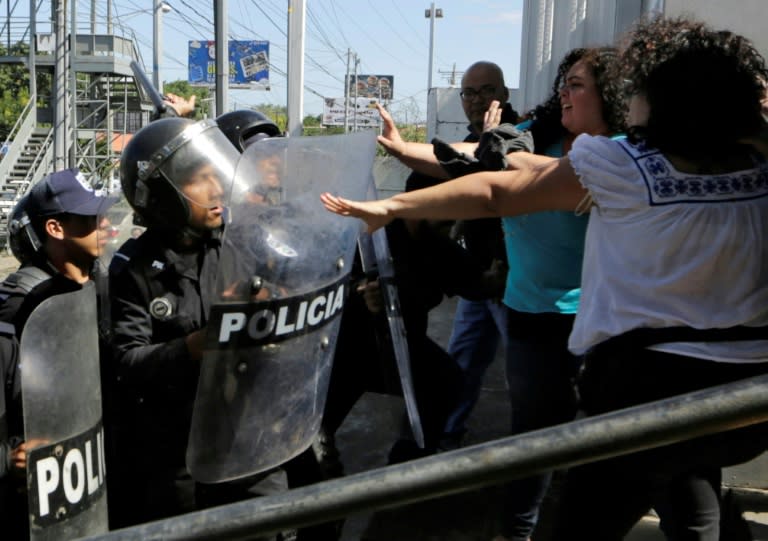 Riot policemen clear journalists from the surroundings of the Plaza El Sol police station as Chamorro (out of frame) tried to speak to National Police Senior Commissioner Francisco Diaz