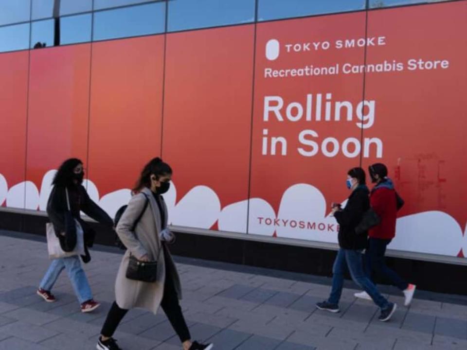 Pedestrians in masks pass downtown Ottawa's Rideau Centre mall late last month. (Jean Delisle/CBC - image credit)