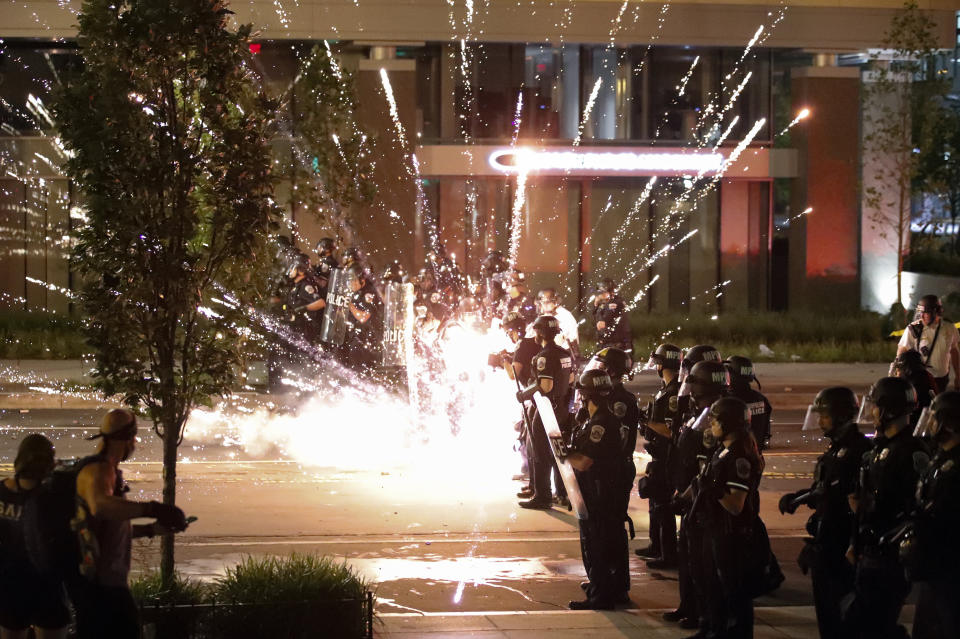 A firework explodes by a police line as demonstrators gather to protest the death of George Floyd.  (Photo: ASSOCIATED PRESS)