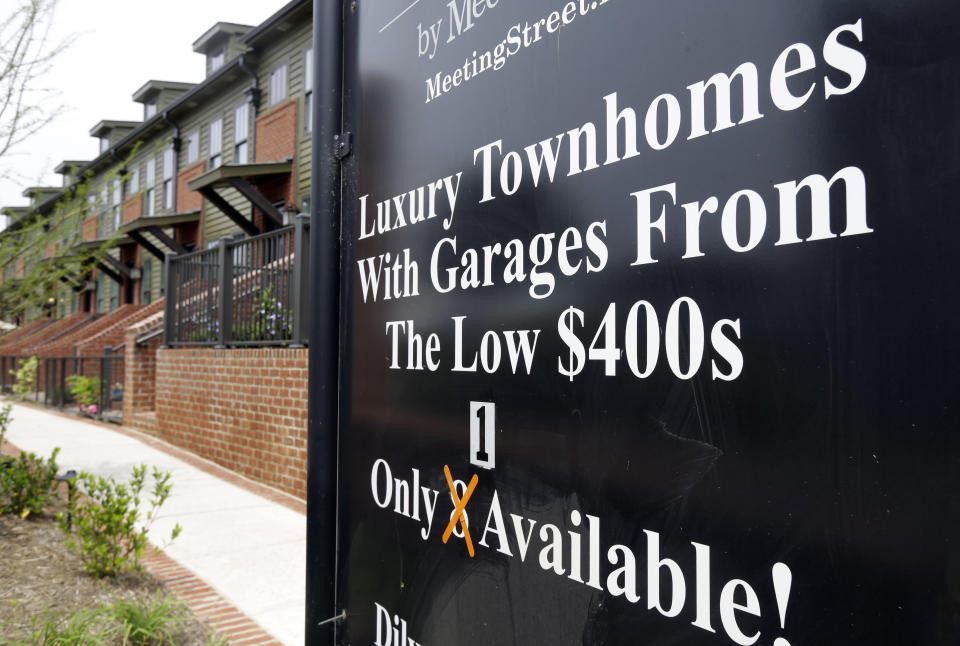 FILE - This Thursday, April 27, 2017, file photo shows a sign promoting town homes for sale, in Charlotte, N.C. A healthy demand for homes and a shrinking supply of available properties has helped keep home prices rising. The Standard & Poor's CoreLogic Case-Shiller home price index, which tracks the value of homes in 20 major U.S. metropolitan areas, is due out Tuesday, Dec. 26, 2017. (AP Photo/Chuck Burton, File)