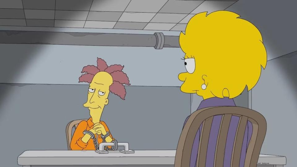 Sideshow Bob with a weird baldish head sits at a table locked up in prison opposite grown Lisa Simpsons on Treehouse of Horror XXXIV