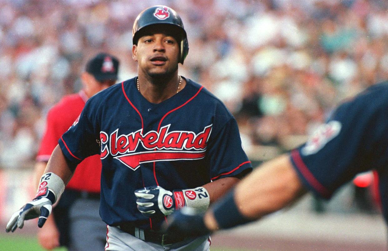 Cleveland Indians' Manny Ramirez heads for home to be congratulated by Jim Thome after hitting a sixth-inning home run  during their game against the Seattle Mariners  in Seattle Sunday, Aug. 22, 1999.