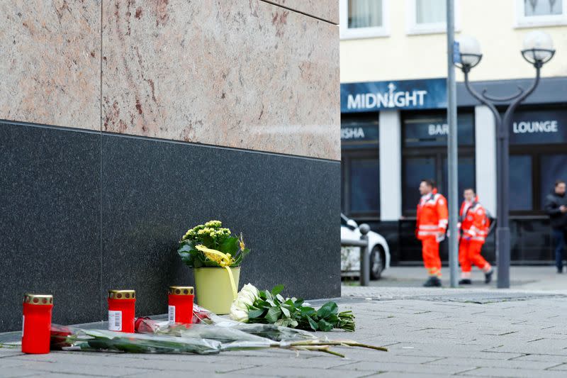 Flowers and candles are placed near the Midnight Shisha bar after a shooting in Hanau