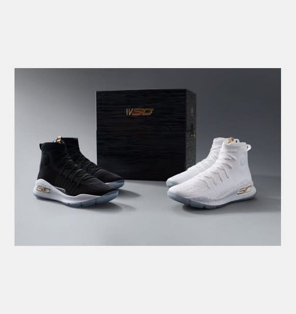 A black pair and white pair of Curry 4's in front of a black box