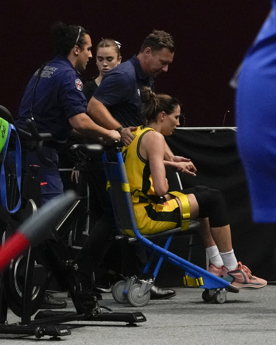Australia's Bec Allen is taken from the arena by medical staff after an injury during their game at the women's Basketball World Cup against Serbia in Sydney, Australia, Sunday, Sept. 25, 2022. (AP Photo/Mark Baker)