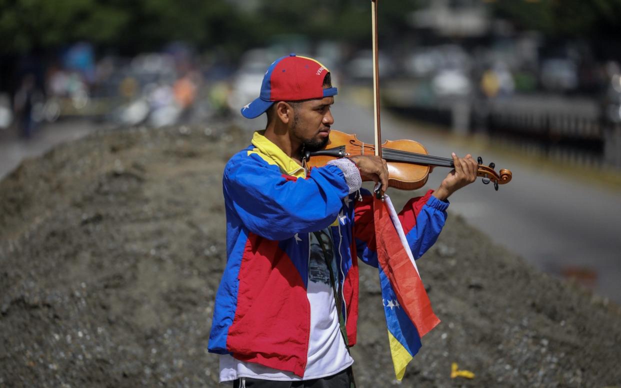 Violinist Wuilly Arteaga participates in a demonstration in Caracas - EFE