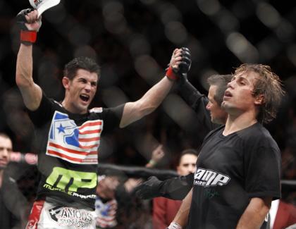 Dominick Cruz, left, celebrates his victory over Urijah Faber at UFC 132. (AP)