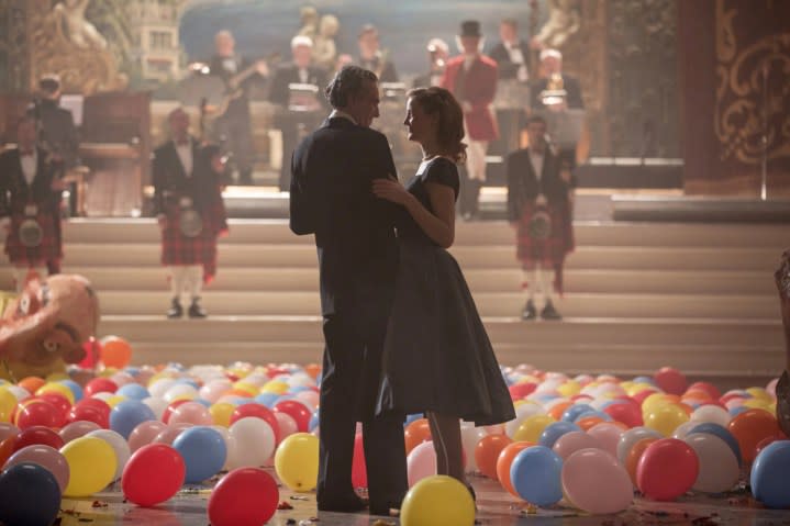 Daniel Day Lewis and Vicky Krieps stand near fallen balloons in Phantom Thread.