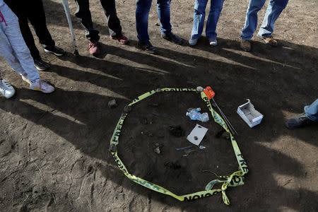 Residents gather items collected during a search for human remains and items that could help to identify their missing relatives and friends at the site where a pipeline ruptured by oil thieves exploded, in the municipality of Tlahuelilpan, state of Hidalgo, Mexico January 20, 2019. REUTERS/Henry Romero