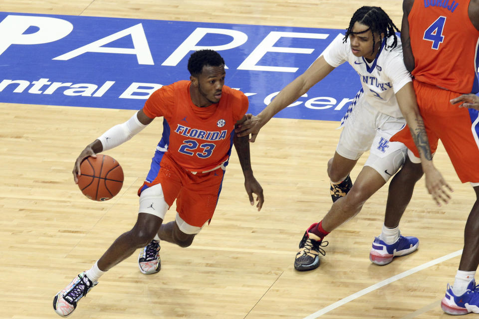 Florida's Scottie Lewis (23) drives near Kentucky's B.J. Boston (3) during the first half of an NCAA college basketball game in Lexington, Ky., Saturday, Feb. 27, 2021. (AP Photo/James Crisp)