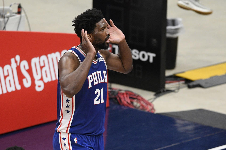 Philadelphia 76ers center Joel Embiid (21) gestures to the crowd after his dunk during the first half of Game 3 in a first-round NBA basketball playoff series against the Washington Wizards, Saturday, May 29, 2021, in Washington. (AP Photo/Nick Wass)