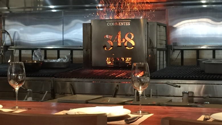 open flame grill and bar top with glassware with Correntes logo