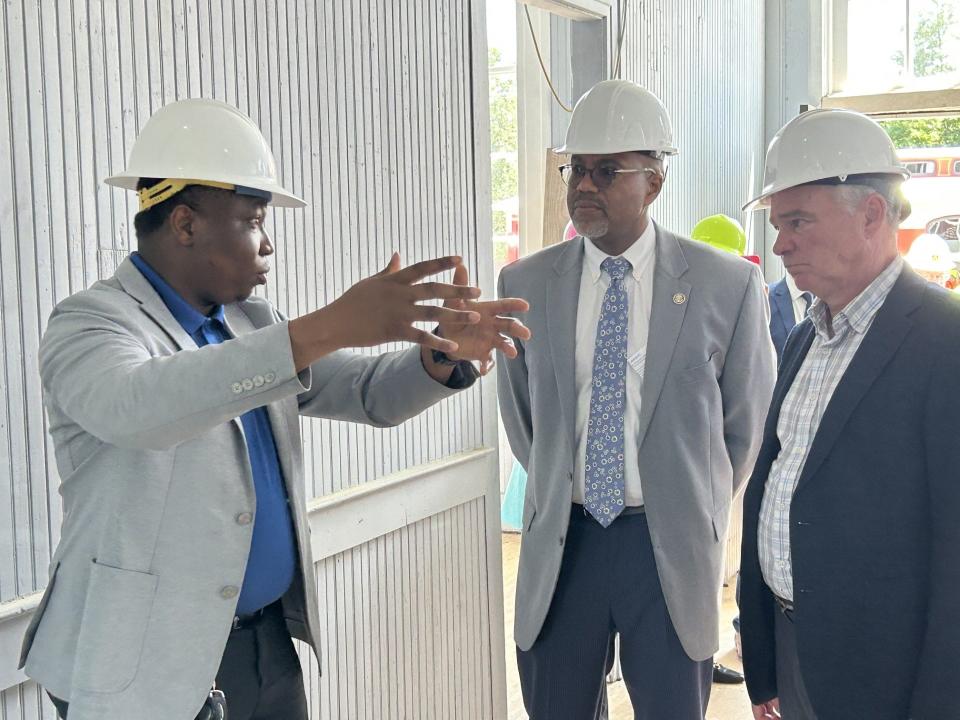 Temidire Okeowo, left, Petersburg's capital improvement projects manager, explains the renovation of South Side Depot to Mayor Sam Parham and Sen. Tim Kaine, D-Virginia, Wednesday, Aug. 16, 2023, on site in Old Towne.