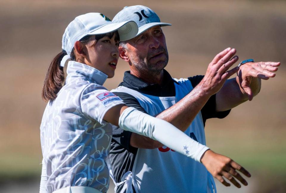 Saki Baba from Japan and her caddie, Beau Brushert, have a discussion on the course during the final match of the 122nd U.S. Women’s Amateur Championship on the Chambers Bay Golf Course in University Place, Wash. on August 14, 2022. Baba secured the win over Monet Chun from Canada by being 10-up and finishing with a birdie on the ninth hole.