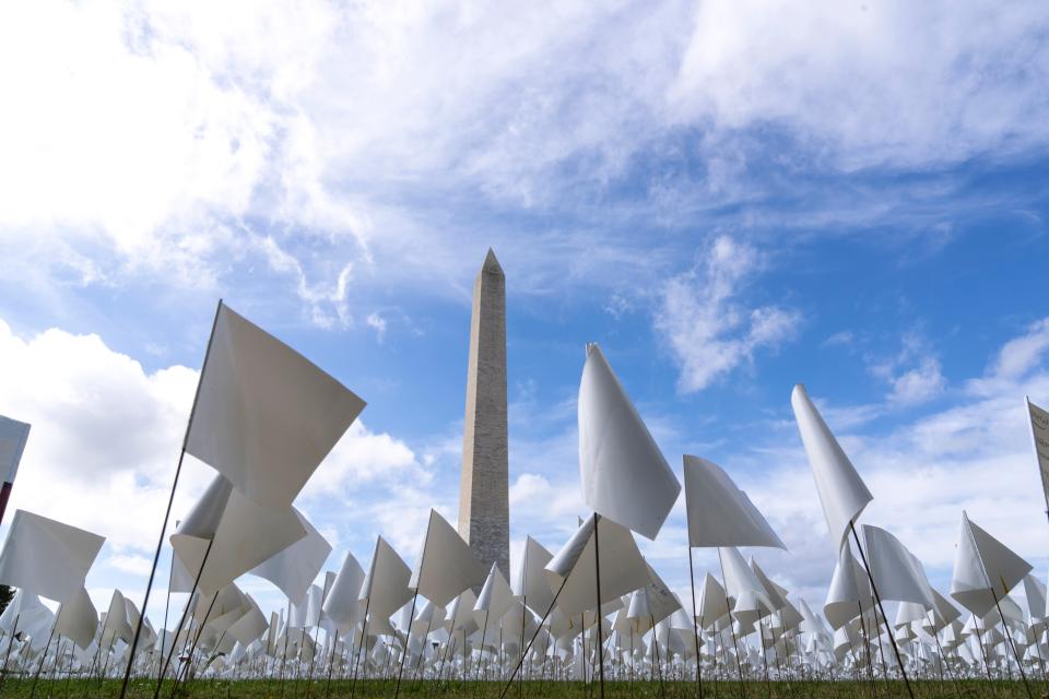The Washington Monument is surrounded by white flags of the public art project "In America: Remember," commemorating the Americans who have died due to COVID-19. The concept by artist Suzanne Brennan Firstenberg was on the National Mall in the fall of 2021.
