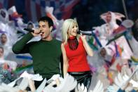 Singers Christina Aguilera (R) and Enrique Iglesias (L) perform during the halftime show at Super Bowl XXXIV at the Georgia Dome in Atlanta, 30 January, 2000. (JEFF HAYNES/AFP via Getty Images)