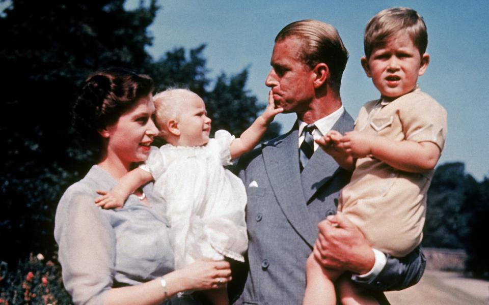 The first color photograph of the Princess Royal, taken in 1951, in the arms of her mother the Queen while her father, Prince Philip, holds her brother Prince Charles  - Keystone-France 