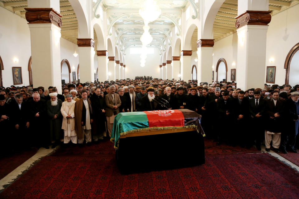 Afghan President Hamid Karzai, center second row, prays amongst others during the funeral procession of Afghanistan's influential Vice President Mohammad Qasim Fahim in Kabul, Afghanistan, Tuesday, March 11, 2014. Fahim, a leading commander in the alliance that fought the Taliban who was later accused with other warlords of targeting civilian areas during the country's civil war, died on Sunday, March 9, 2014. He was 57. (AP Photo/Rahmat Gul)