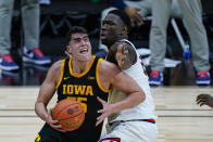 Illinois center Kofi Cockburn, right, defends against Iowa center Luka Garza (55) in the first half of an NCAA college basketball game at the Big Ten Conference tournament in Indianapolis, Saturday, March 13, 2021. (AP Photo/Michael Conroy)