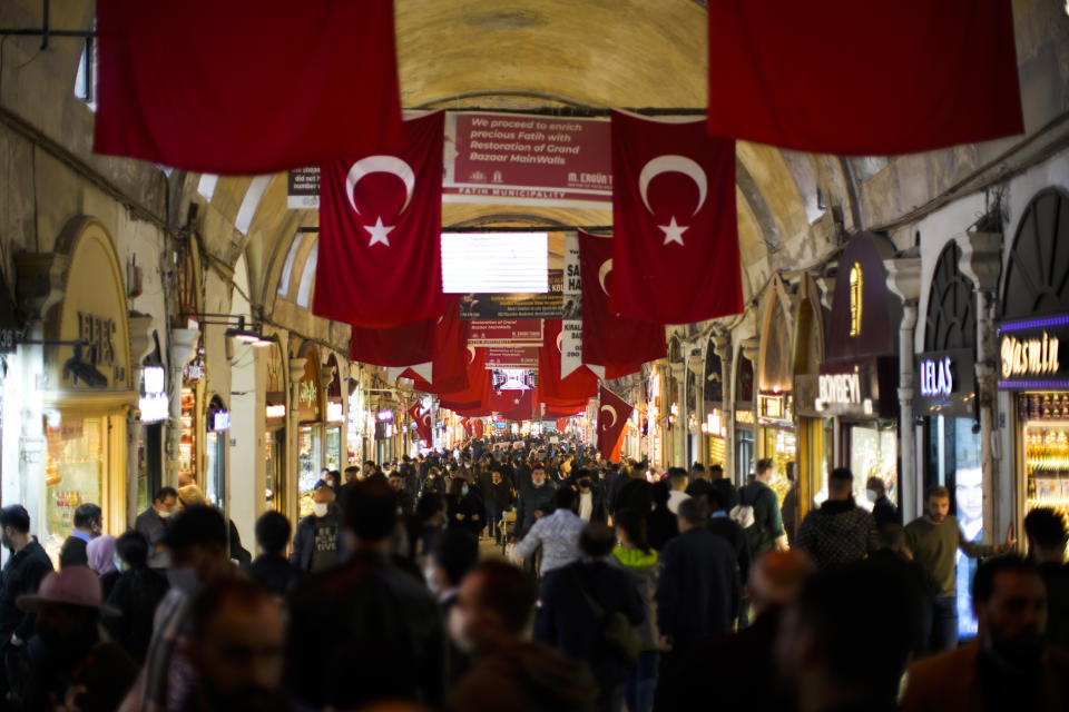 People walk along the Grand Bazaar in Istanbul, Turkey, Tuesday, Nov. 2, 2021. Many Turkish consumers are faced with increased hardship as prices of food and other goods have soared in recent years. The yearly consumer price index increased by 19.9% in October, up from 19.58% in September, according to official data by the Turkish Statistical Institute released on Nov. 3. (AP Photo/Francisco Seco)