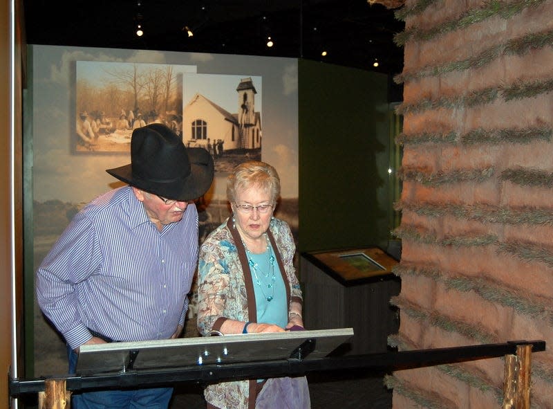 Visitors read a sod house display at the Cherokee Strip Regional Heritage Center in Enid.