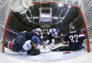 Team USA's goalie Jonathan Quick (R) makes a save against Finland's Jussi Jokinen (C) as Team USA's Ryan McDonagh lies on top of Finland's Kimmo Timonen (44) during the first period of their men's ice hockey bronze medal game at the Sochi 2014 Winter Olympic Games February 22, 2014. REUTERS/Martin Rose/Pool (RUSSIA - Tags: SPORT ICE HOCKEY OLYMPICS)