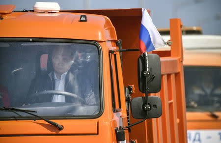 Russian President Vladimir Putin drives a Kamaz truck during a ceremony opening a bridge, which was constructed to connect the Russian mainland with the Crimean Peninsula across the Kerch Strait, May 15, 2018. Alexander Nemenov/Pool via REUTERS