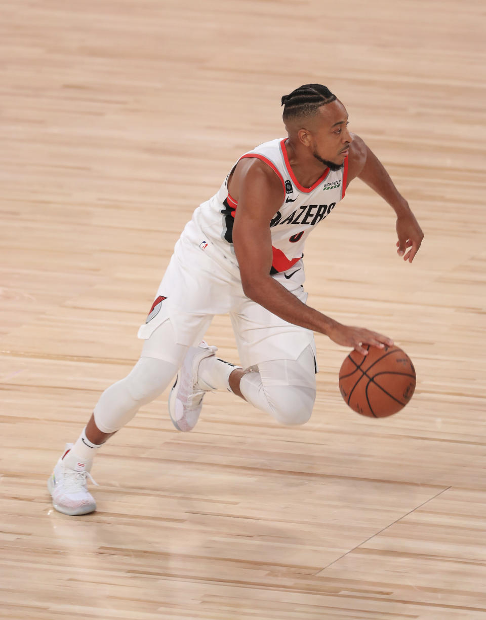 Portland Trail Blazers' CJ McCollum dribbles during the first half of an NBA basketball game against the Memphis Grizzlies, Friday, July 31, 2020, in Lake Buena Vista, Fla. (Mike Ehrmann/Pool Photo via AP)