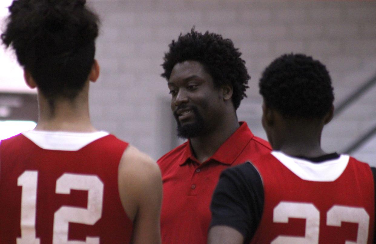 North Florida Educational Institute coach Stacey Poole Jr. talks with players during high school boys basketball practice on Monday.