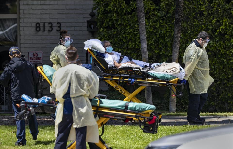 <span class="caption">EMTs evacuate patients from a nursing home in Riverside, California. Older people tend to have the most severe infections.</span> <span class="attribution"><a class="link " href="https://www.gettyimages.com/detail/news-photo/patient-is-removed-from-magnolia-rehabilitation-and-nursing-news-photo/1209845309?adppopup=true" rel="nofollow noopener" target="_blank" data-ylk="slk:Getty Images/Los Angeles Times/Gina Ferazzi;elm:context_link;itc:0;sec:content-canvas">Getty Images/Los Angeles Times/Gina Ferazzi</a></span>