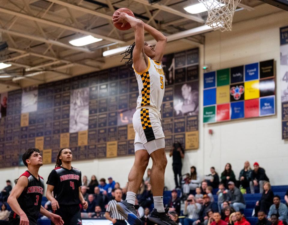 Archbishop Wood's Josh Reed (5) goes for a slam dunk against Northeast High during Tuesday's District 12 playoff game.