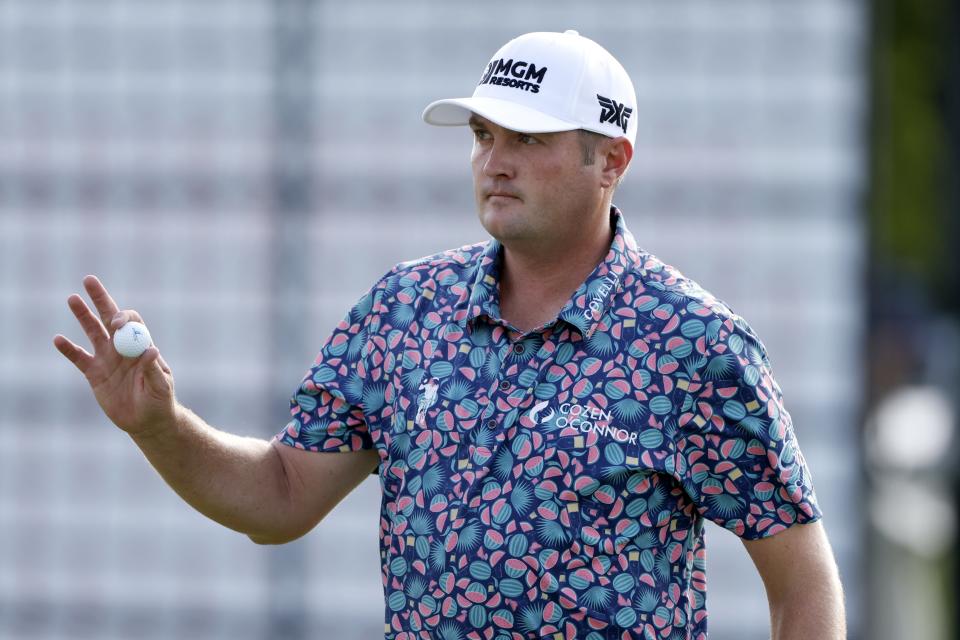 Jason Kokrak acknowledges the gallery after playing through the 18th green during the third round of the Charles Schwab Challenge golf tournament at Colonial Country Club in Fort Worth, Texas, Saturday May 29, 2021. (AP Photo/Ron Jenkins)