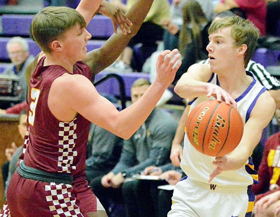 Watertown's Kohen Kranz is trapped by Sioux Falls Roosevelt defenders Hayden Goff (3) and Abraham Kamara (hidden) during their high school boys basketball game on Friday, February 10, 2023 in the Watertown Civic Arena.