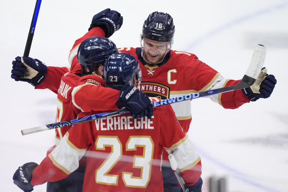 Florida Panthers center Aleksander Barkov (16) and left wing Matthew Tkachuk, left, congratulate center Carter Verhaeghe (23) after Verhaeghe scored a goal during the third period of Game 5 of the first-round of an NHL Stanley Cup Playoff series against the Tampa Bay Lightning, Monday, April 29, 2024, in Sunrise, Fla. (AP Photo/Wilfredo Lee)