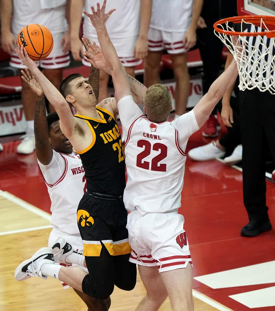 Iowa forward Ben Krikke gets to the basket between Wisconsin guard AJ Storr and forward Steven Crowl during their game this month in Madison.