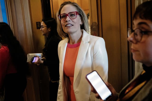 Bill O'Leary/The Washington Post via Getty Images Sen. Kyrsten Sinema speaks with reporters in Washington