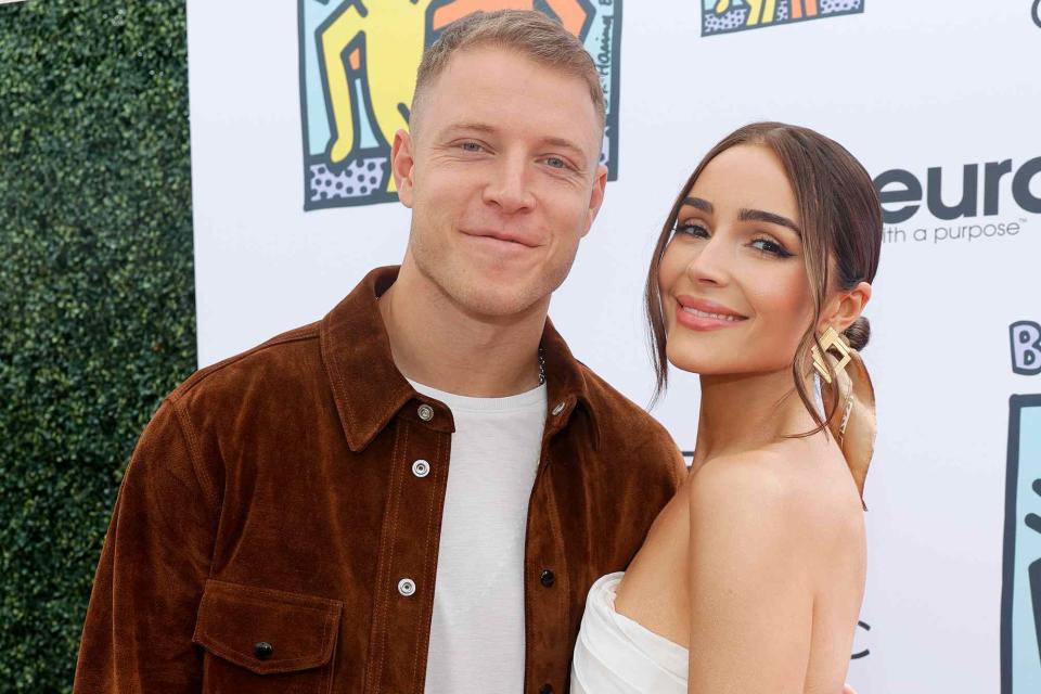 <p>Stefanie Keenan/Getty </p> Christian McCaffrey and Olivia Culpo