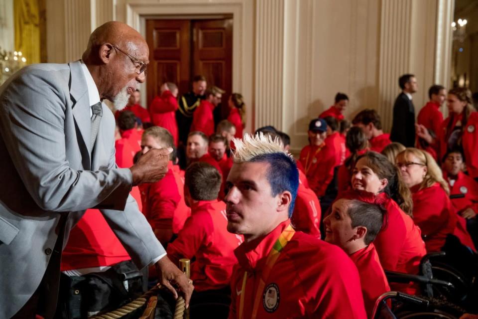 <p>1968 Olympic athlete John Carlos, left, speaks with members of the 2016 United States Summer Paralympic Team following a ceremony in the East Room of the White House in Washington, Thursday, Sept. 29, 2016, where President Barack Obama honored the 2016 United States Summer Olympic and Paralympic Teams. Carlos, along with athlete Tommie Smith extended their gloved hands skyward in racial protest during the playing of “The Star-Spangled Banner” after Smith received the gold and Carlos the bronze medal in the 200 meter run at the Summer Olympic Games in Mexico City 1968. (AP Photo/Andrew Harnik)</p>