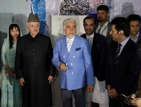 Afghan presidential candidate Abdullah Abdullah arrives to cast his vote at a polling station in Kabul