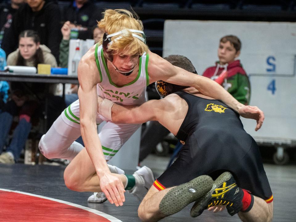 St. Mary's Kyle Holtberg, left, grapples with Oakdale's Eziequel Vela in the boys 126-lb weight class of the Sac-Joaquin Section Masters Boys Wrestling Tournament at the Adventist Health arena in downtown Stockton on Feb. 16, 2024.