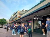 Customers line up outside Starbucks' historic first location in Pike Place Market in Seattle