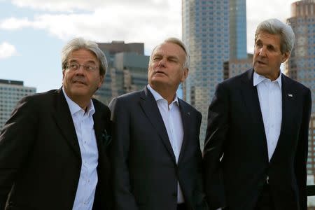 Italian Foreign Minister Paolo Gentiloni (L), French Foreign Minister Jean-Marc Ayrault (C) and U.S. Secretary of State John Kerry look out during a cruise through Boston Harbor with European Union High Representative Federica Mogherini, British Foreign Secretary Boris Johnson and German Foreign Minister Frank-Walter Steinmeier in Boston, Massachusetts, U.S. September 24, 2016. REUTERS/Brian Snyder