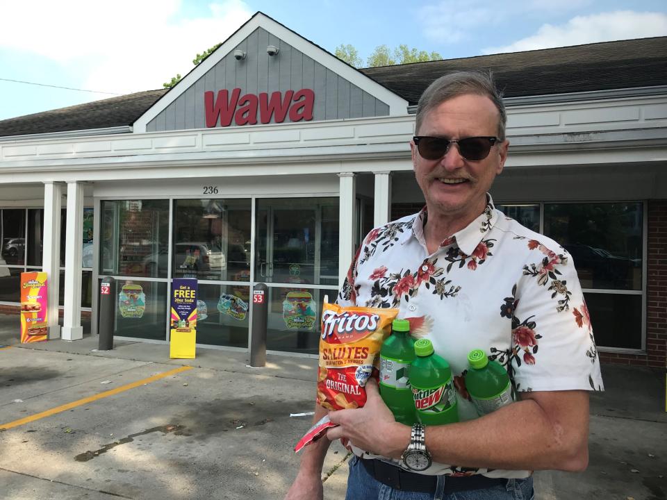 Loyal Wawa customer Mike Williams of Moorestown leaves his vintage hometown  Wawa on Main Street with snack goodies like M&Ms and drinks Wednesday afternoon,  June 27, 2023.