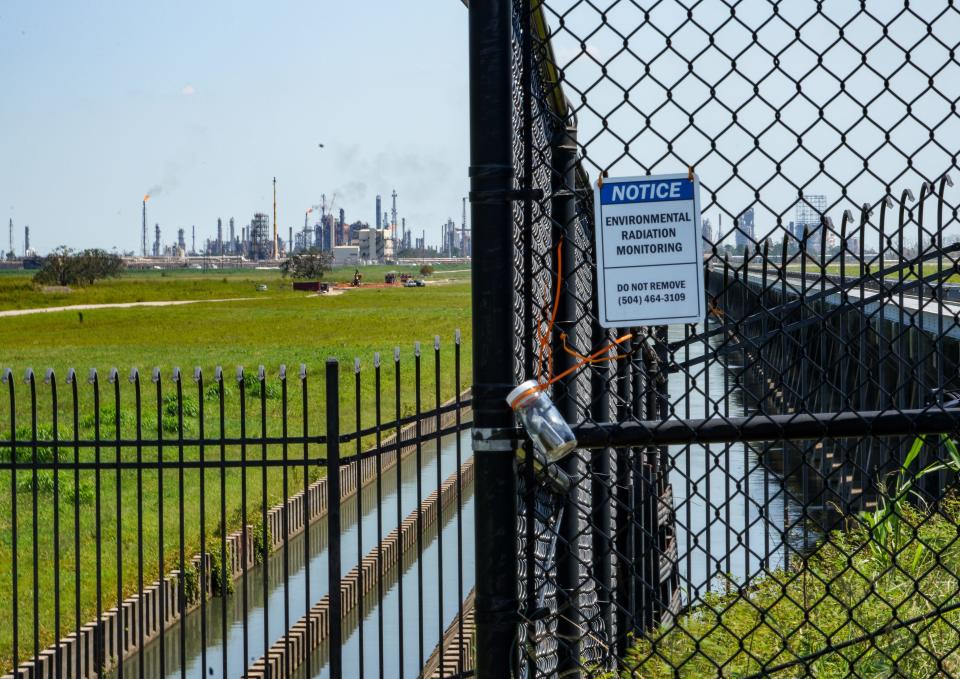 A sign warns people not to disturb a radiation-monitoring system near refineries along the Mississippi River outside New Orleans.