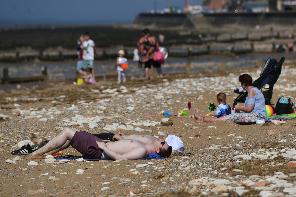 Thousands are expected to visit the beach over the weekend, despite warnings of some rain (PA)